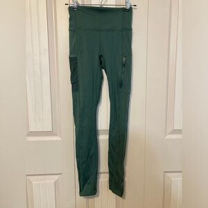 Women’s green Fabletics athletic leggings.